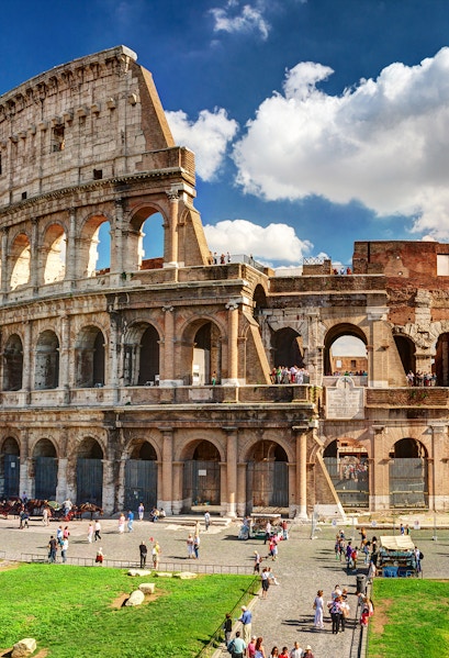 Colosseum in Rome with tourists exploring the ancient amphitheater.