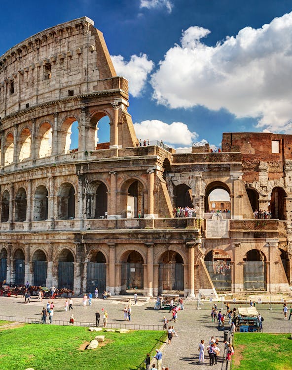 Colosseum in Rome with tourists exploring the ancient amphitheater.