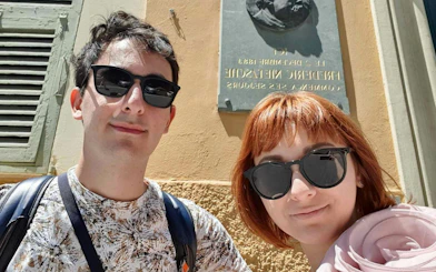 Self-guided city exploration in Nice with historical plaque in background.