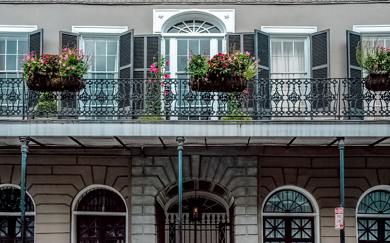 LaLaurie Mansion balcony with ironwork and flowers, New Orleans haunted site.