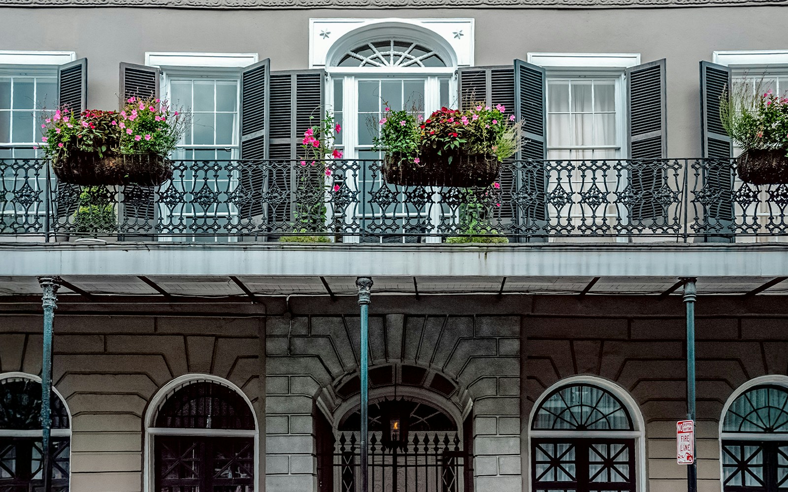 LaLaurie Mansion balcony with ironwork and flowers, New Orleans haunted site.