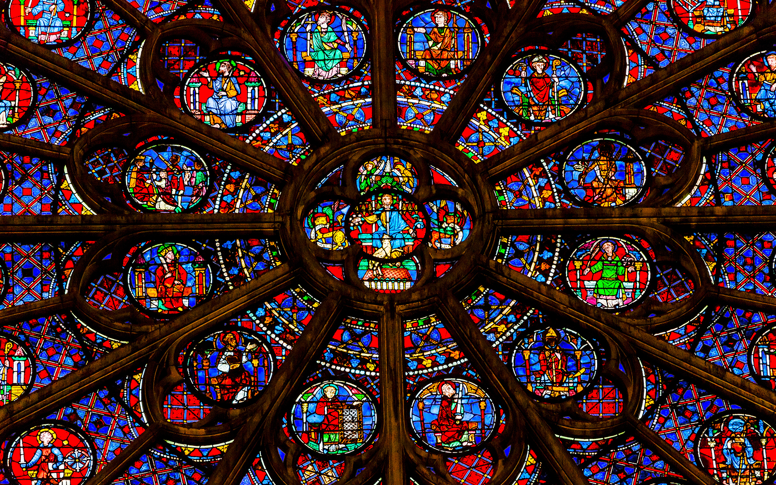 Rose window detail in Notre Dame Cathedral, Paris, featuring vibrant stained glass.