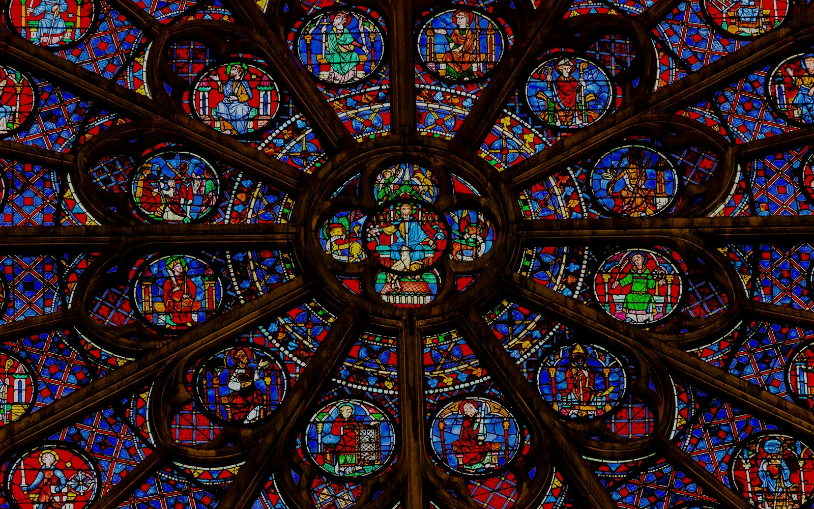 Rose window in Notre Dame Cathedral, Paris, showcasing intricate stained glass design.