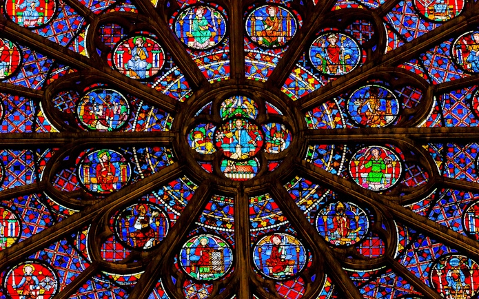 Rose window detail in Notre Dame Cathedral, Paris, featuring vibrant stained glass.