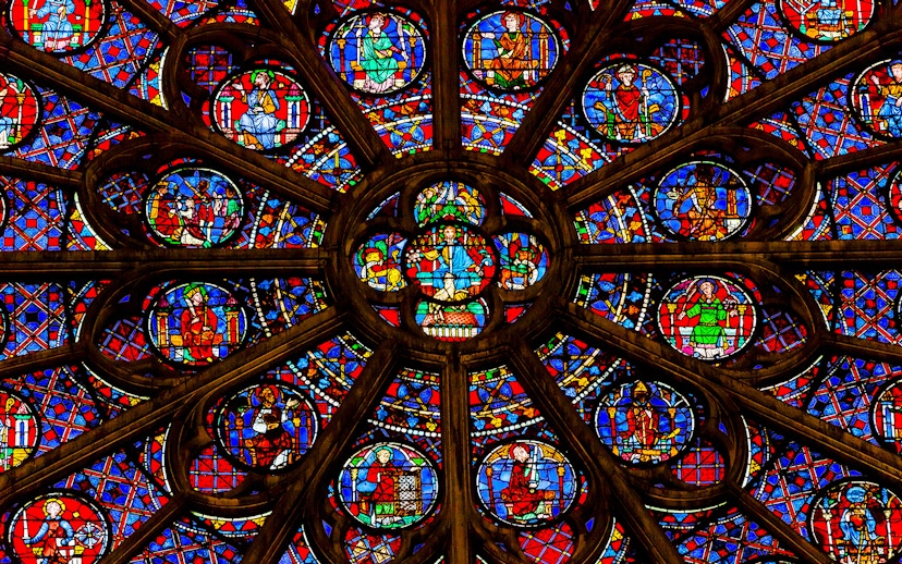 Rose window detail in Notre Dame Cathedral, Paris, featuring vibrant stained glass.