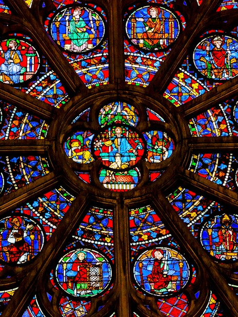 Rose window detail in Notre Dame Cathedral, Paris, featuring vibrant stained glass.