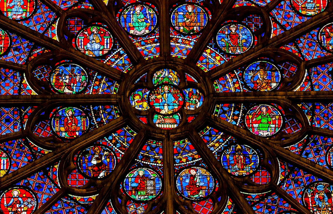 Rose window in Notre Dame Cathedral, Paris, showcasing intricate stained glass design.