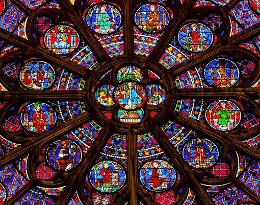 Rose window in Notre Dame Cathedral, Paris, showcasing intricate stained glass design.