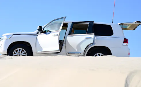 Desert safari vehicle on sand dunes in Doha, Qatar.