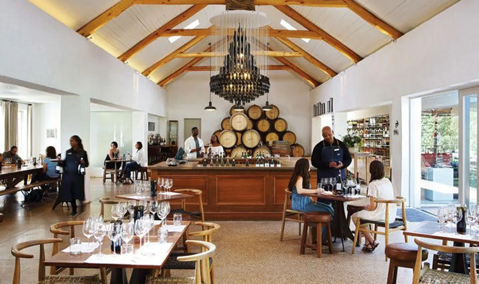 Wine tasting room with guests and staff at a Cape Town winery.