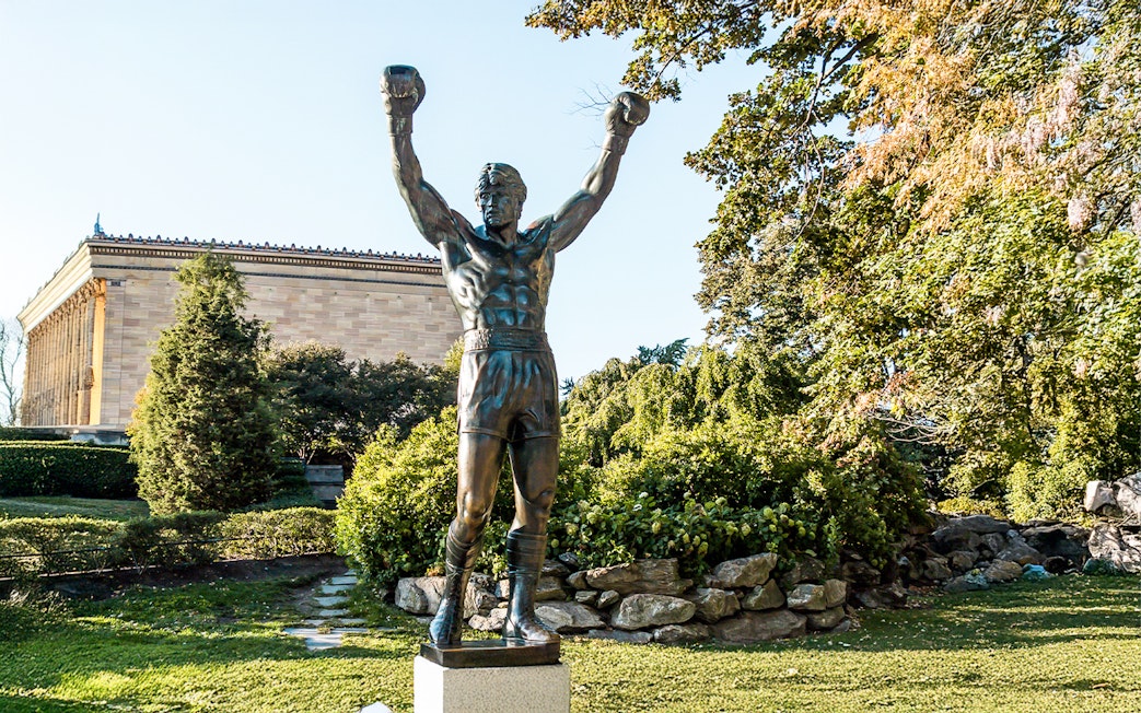 Rocky Balboa statue with raised arms near Philadelphia Museum of Art.