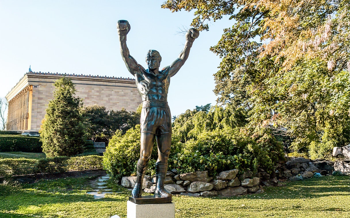 Rocky Balboa statue with raised arms near Philadelphia Museum of Art.