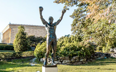 Rocky Balboa statue with raised arms near Philadelphia Museum of Art.