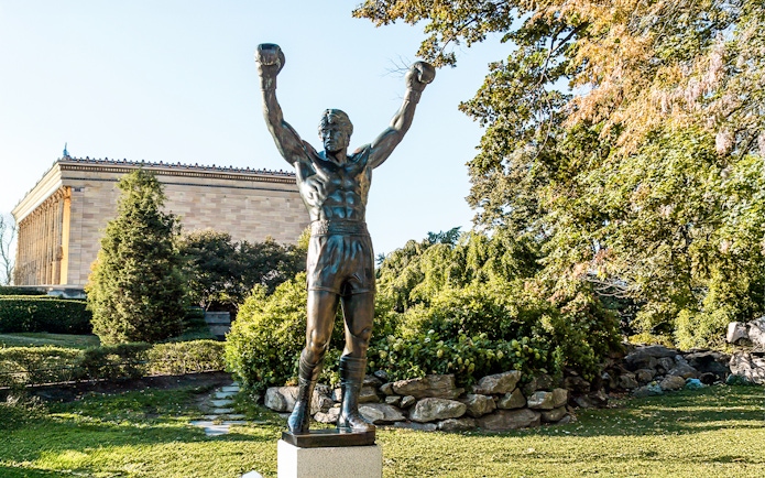Rocky Balboa statue with raised arms near Philadelphia Museum of Art.