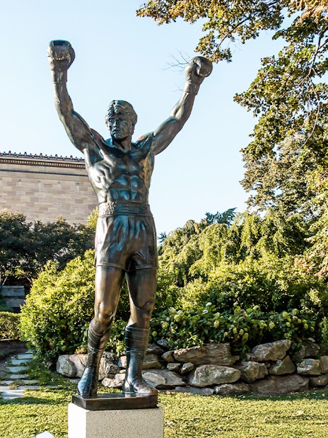 Rocky Balboa statue with raised arms near Philadelphia Museum of Art.