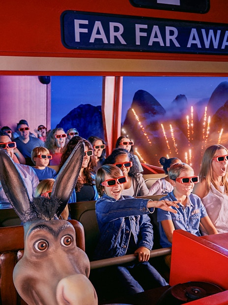 Visitors enjoying a 4D ride at Shrek’s Adventure! London with 3D glasses and animated effects.