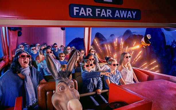 Visitors enjoying a 4D ride at Shrek’s Adventure! London with 3D glasses and animated effects.