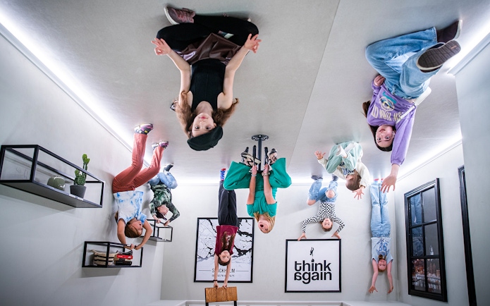 Visitors experiencing an upside-down room at Paradox Museum, Stockholm.