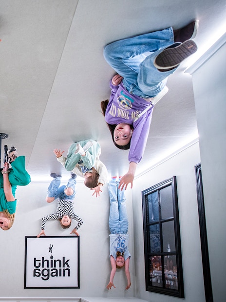 Visitors experiencing an upside-down room at Paradox Museum, Stockholm.