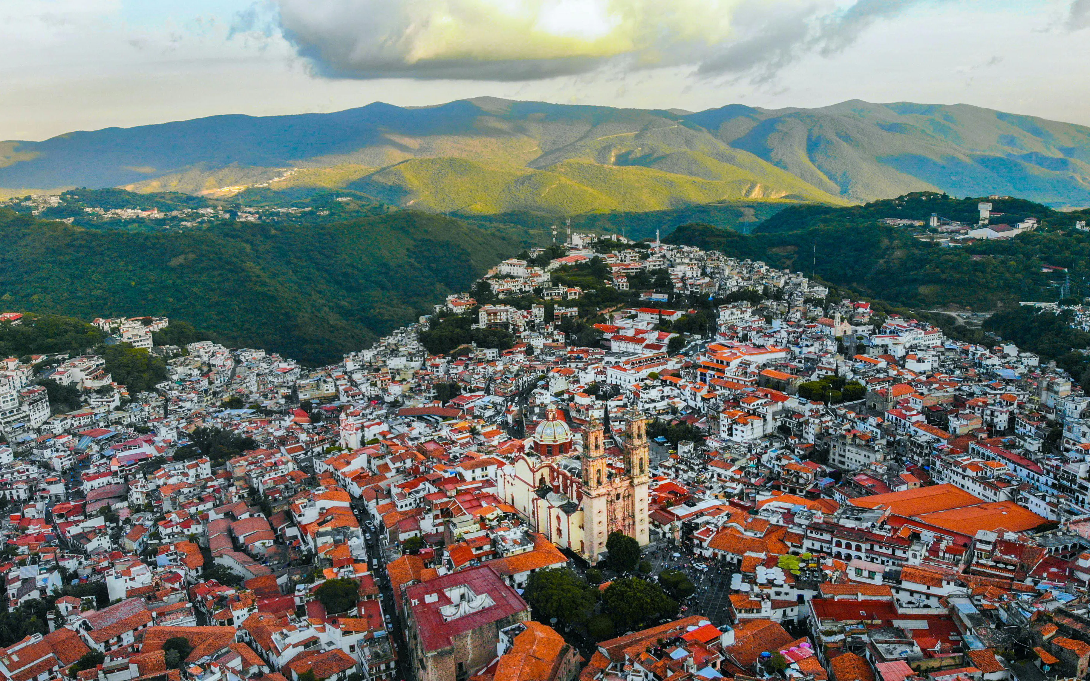 Aerial view of Taxco with Santa Prisca Church and surrounding hills, Mexico City day tour.