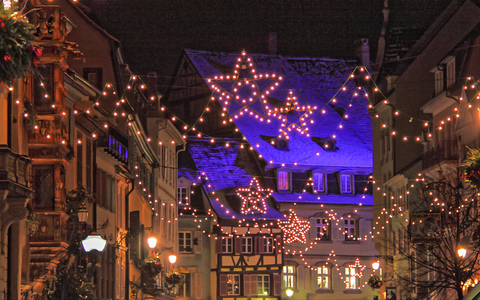 Festive lights and star decorations in Village de Noël, Nice during New Year celebrations.