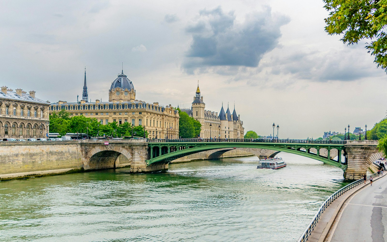 Bataeux Mouches ship on Seine river in Paris with a view of Notre Dame in background