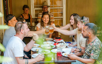 Guests toasting with beers during The Castle Side with Czech Food & Beer tour.