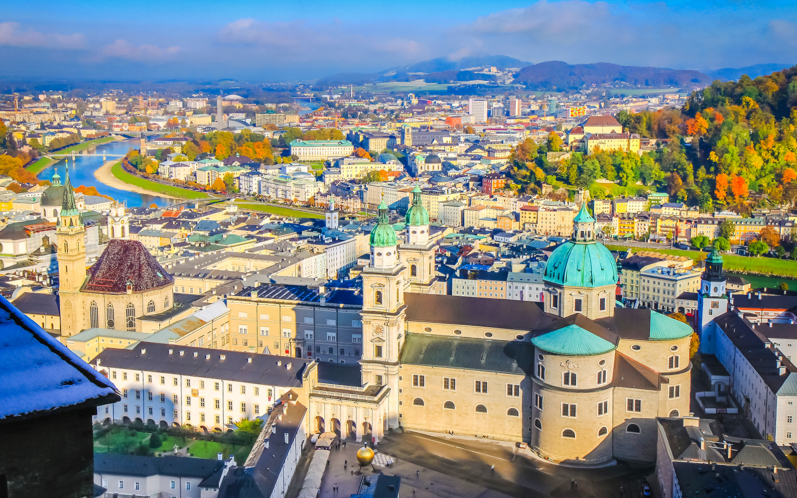 Aerial view of Salzburg's medieval old town with Salzach River and historic buildings.