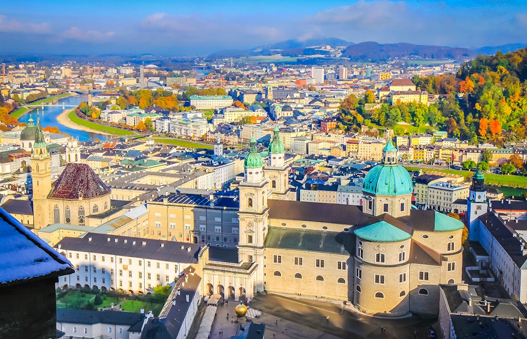 Aerial view of Salzburg's medieval old town with Salzach River and historic buildings.