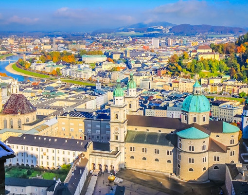 Aerial view of Salzburg's medieval old town with Salzach River and historic buildings.