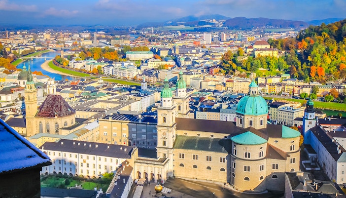 Aerial view of Salzburg's medieval old town with Salzach River and historic buildings.