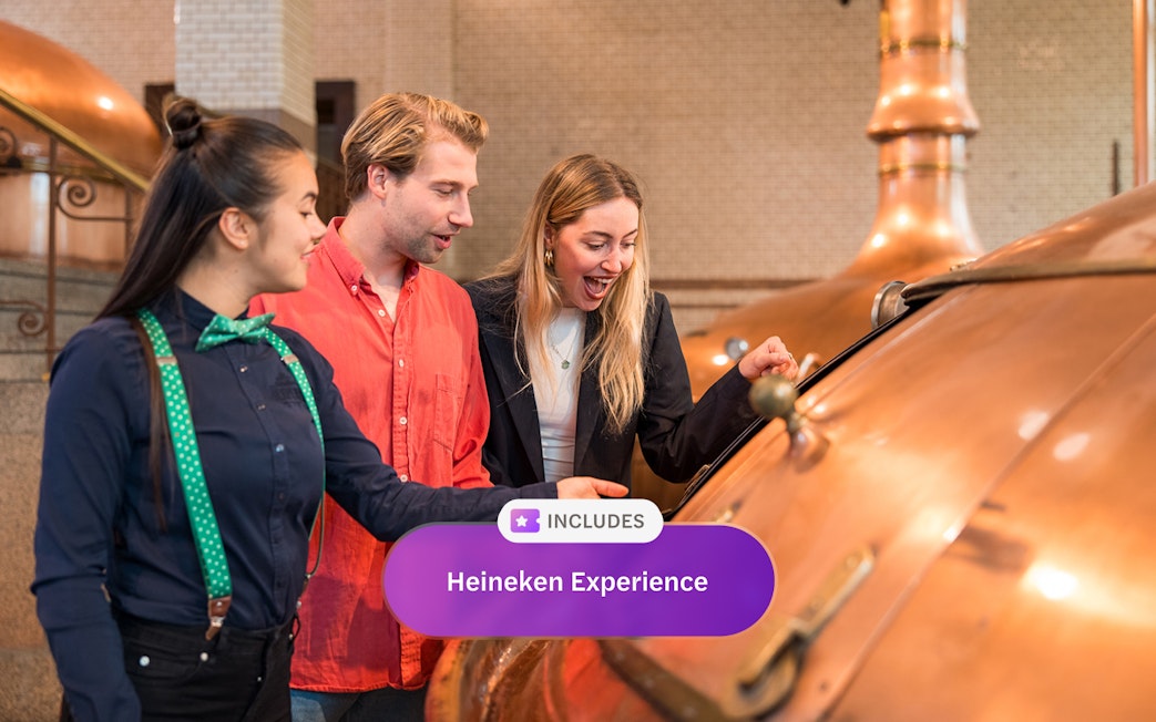 Visitors exploring brewing equipment at Heineken Experience, Amsterdam.