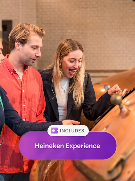 Visitors exploring brewing equipment at Heineken Experience, Amsterdam.