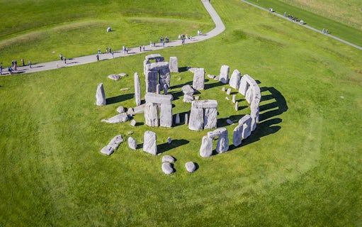 Stonehenge aerial view with tourists on a path, part of a half-day tour from London.