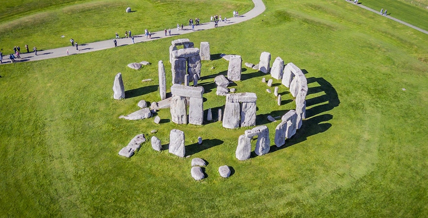 Stonehenge aerial view with tourists on a path, part of a half-day tour from London.