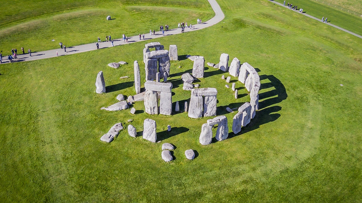 Stonehenge aerial view with tourists on a path, part of a half-day tour from London.