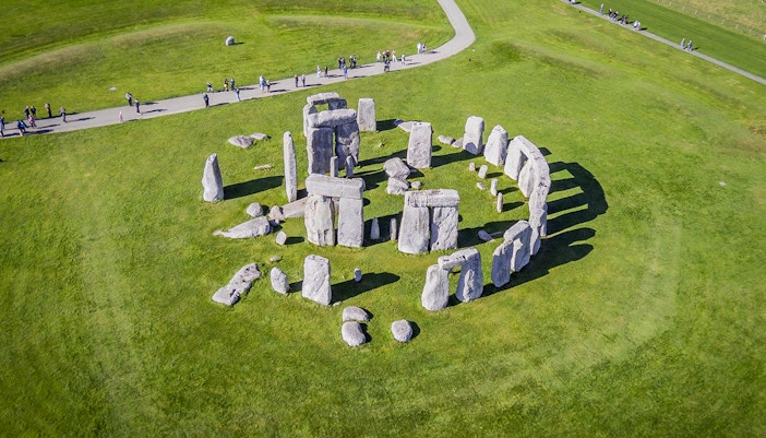 Stonehenge aerial view with tourists on a path, part of a half-day tour from London.