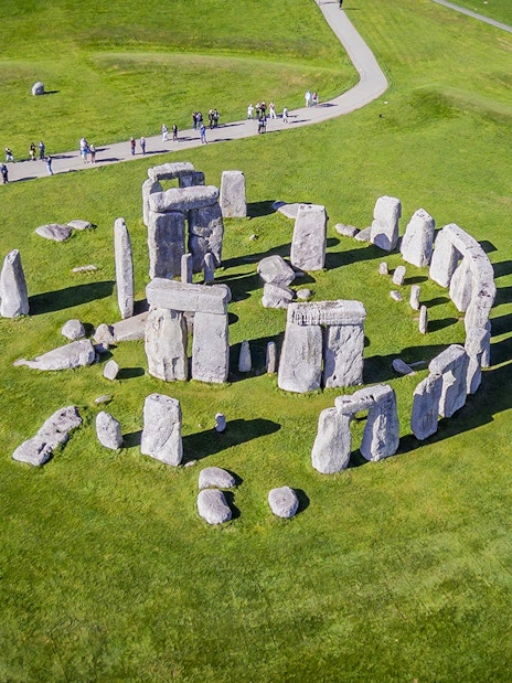 Stonehenge aerial view with tourists on a path, part of a half-day tour from London.