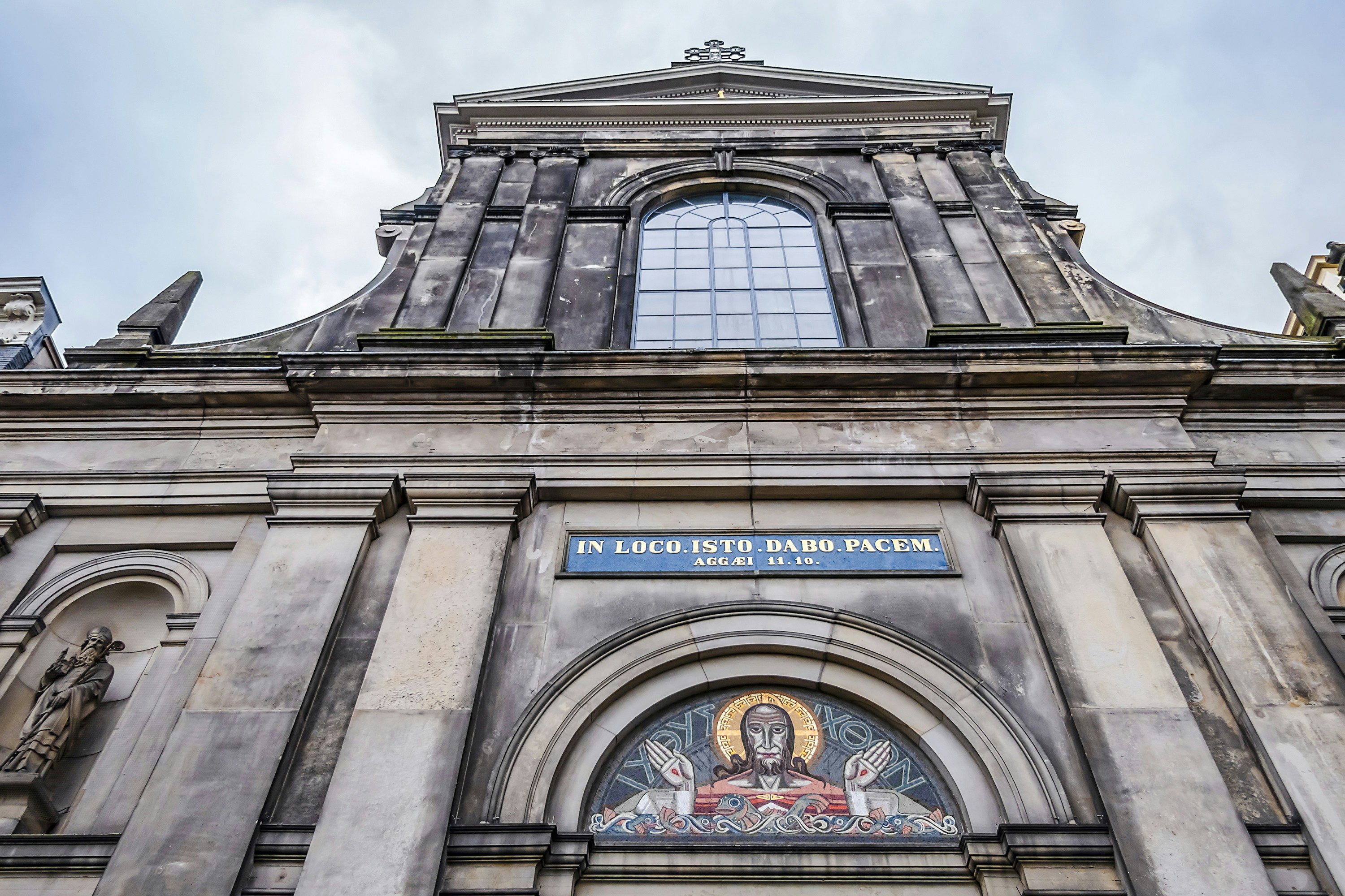 De Duif church facade with religious mosaic and inscription, Prinsengracht, Amsterdam.