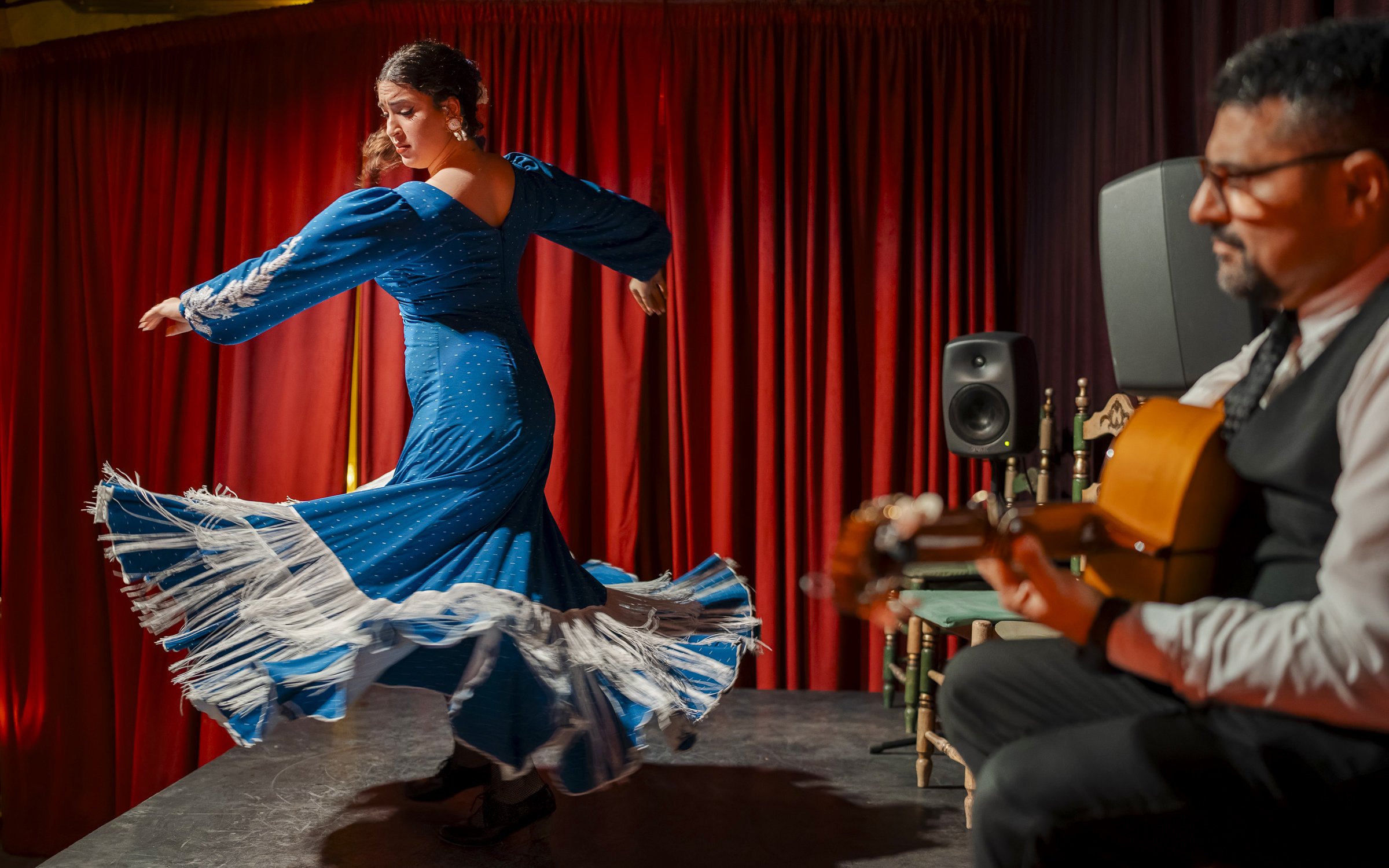 Flamenco dancer performing at Palau Dalmases with guitarist in Barcelona.