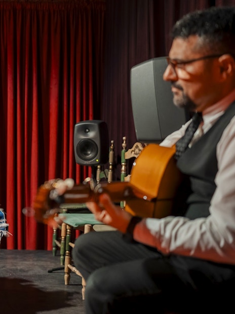 Flamenco dancer performing at Palau Dalmases with guitarist in Barcelona.