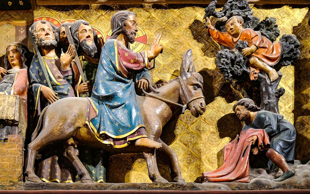 Notre-Dame Cathedral Paris sculpture depicting biblical scene with figures and donkey.