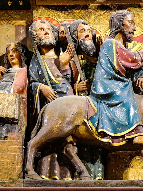 Notre-Dame Cathedral Paris sculpture depicting biblical scene with figures and donkey.