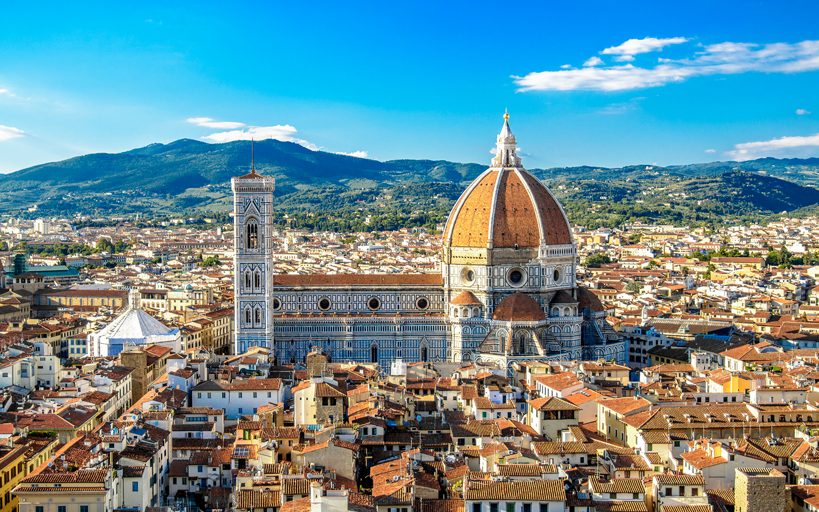 Tour guide leading a group at the Florence Duomo, preparing for the optional Cupola Climb, in Florence, Italy