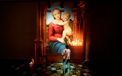 Visitor viewing Raphael's Madonna projection at Fabrique des Lumières exhibit.