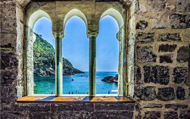 View of the sea through arched windows at Abbazia di San Fruttuoso, Genoa.