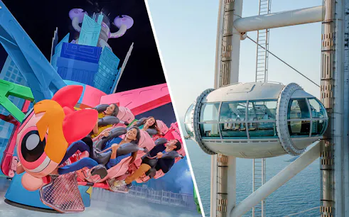 Ain Dubai pod overlooking the sea next to a colorful amusement ride.