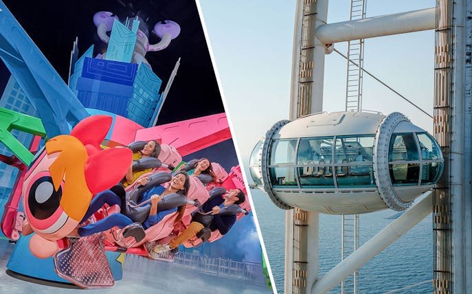 Ain Dubai pod overlooking the sea next to a colorful amusement ride.