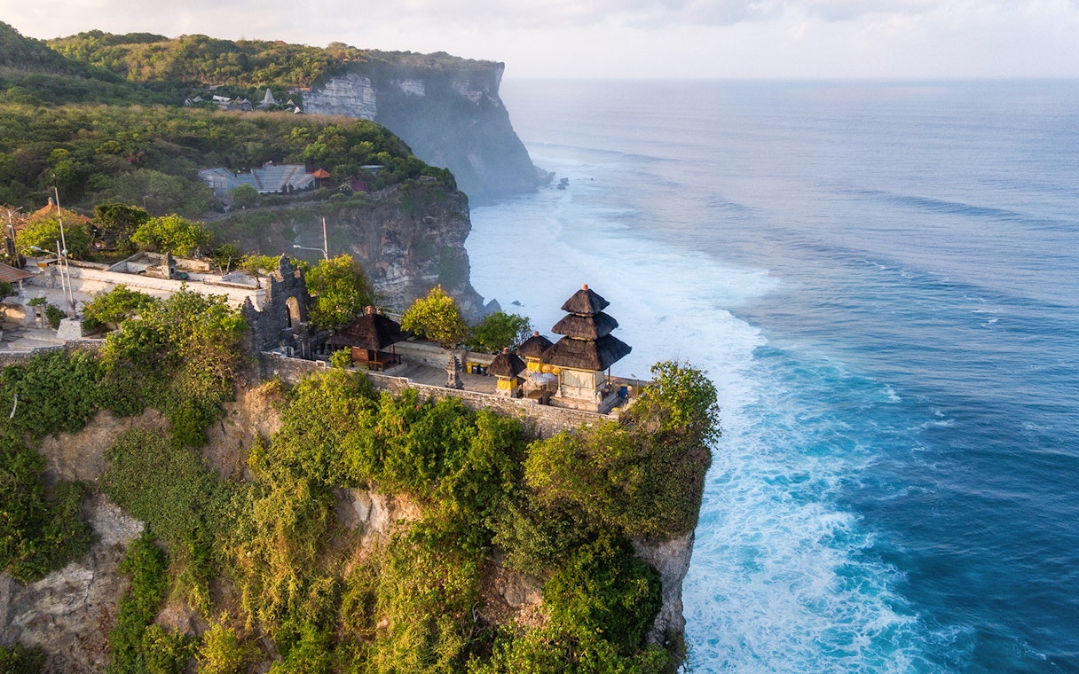 Uluwatu Temple perched on a cliff overlooking the ocean in Bali, Indonesia.