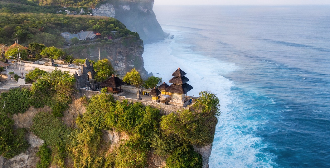 Uluwatu Temple perched on a cliff overlooking the ocean in Bali, Indonesia.